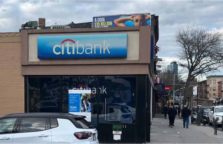 Photograph of Citibank building logo on the typical blue gradient background.