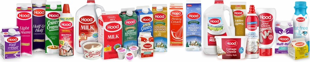 Wide lineup of Hood dairy products including milk jugs, half and half cartons, whipped cream, cottage cheese, heavy cream, and eggnog, all featuring the red oval Hood logo on a white background.