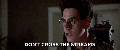 Animated GIF of Egon Spengler from Ghostbusters wearing glasses and a proton pack, with caption DONT CROSS THE STREAMS