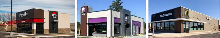 Three current fast-food storefronts from left to right: 1. modern Pizza Hut with flat dark brown and stone facade, red awning detail, and block Pizza Hut logo, 2. modern Taco Bell with white and gray box shape, purple awnings and bell logo tower, 3. modern McDonald's with flat black facade and small yellow M logo — showing the contemporary minimalist redesigns that replaced the red roofs.